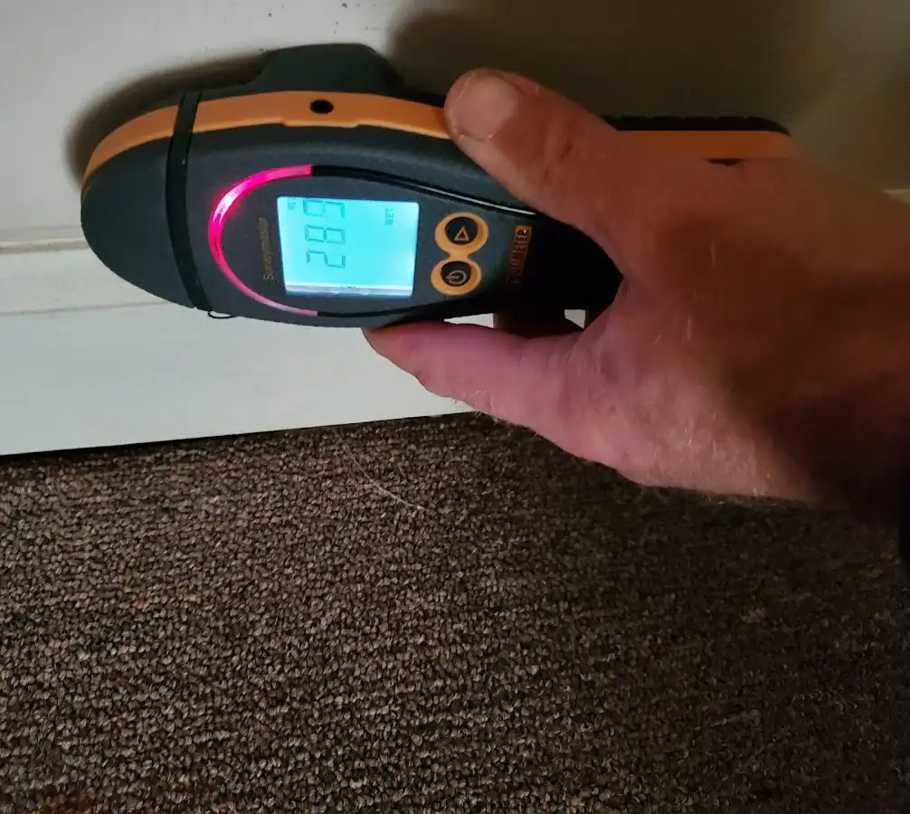 Moisture detection at baseboard during Storm Damage Restoration in Greenacres